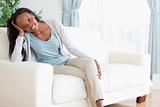 Woman enjoys sitting on the couch