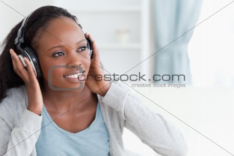Close up of woman enjoying music on the sofa