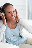 Close up of woman enjoying music on the couch