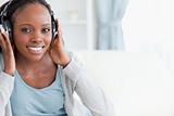 Close up of woman listening to music on couch