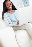 Young woman on couch with laptop
