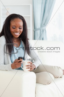Woman on sofa texting
