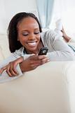 Close up of woman texting on sofa