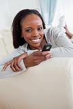 Close up of woman texting on couch