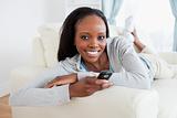 Woman relaxing on sofa while texting