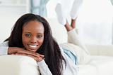 Smiling woman lying on couch