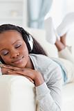 Close up of woman enjoying music on couch