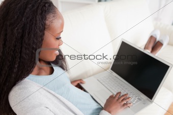 Woman on sofa with her notebook