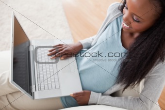 Woman on couch with her notebook