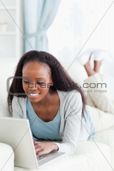Close up of woman on sofa surfing the internet