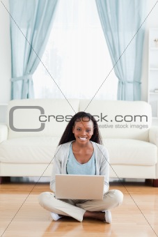 Woman sitting on floor with her notebook