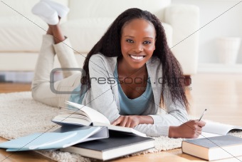 Woman lying on floor working on book review