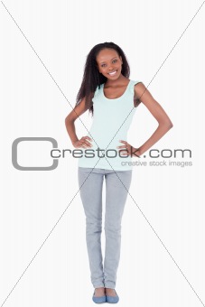 Woman with arms akimbo on white background