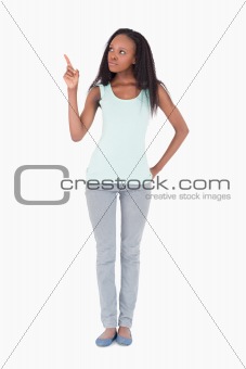 Woman pointing at something on a white background
