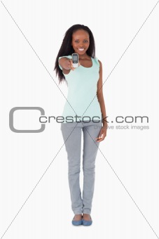 Woman showing her cellphone on white background
