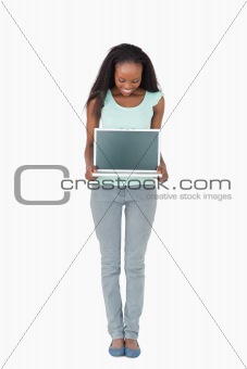 Woman showing her laptop screen on white background