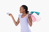 Woman with her shopping and credit card on white background