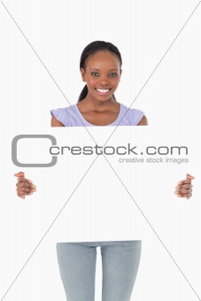 Close up of woman presenting placeholder on white background