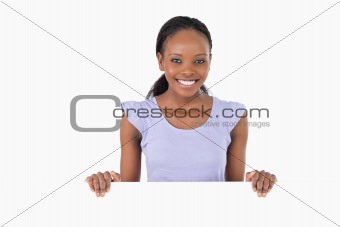 Woman with placeholder in her hands on white background
