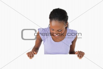 Woman looking down on placeholder on white background