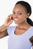 Close up of woman talking on the phone against a white background