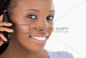 Close up of woman listening closely to caller on white background