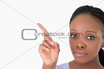 Close up of woman showing something next to her on white background