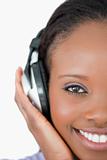 Close up of young woman with headphones on white background