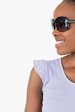 Close up of smiling woman with sunglasses on white background