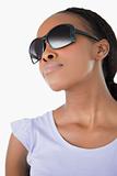 Close up of woman wearing her sunglasses against a white background