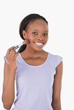 Close up of woman with make-up brush against a white background