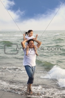 happy father with little girl on the beach