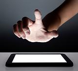 hand touching the touch screen of tablet pc