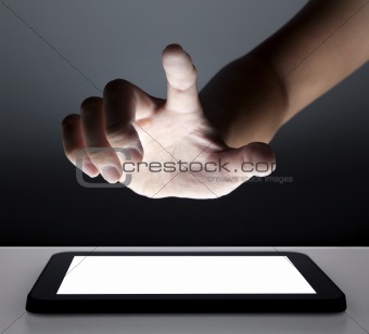 hand touching the touch screen of tablet pc
