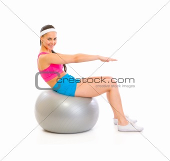 Happy fit female doing abdominal crunch on fitness ball