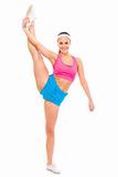 Full lenght portrait of smiling fit female standing in gym split
