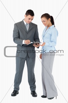 Business partner looking at clipboard against a white background