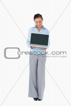 Businesswoman showing laptop against a white background