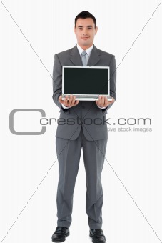 Confident businessman presenting his notebook against a white background