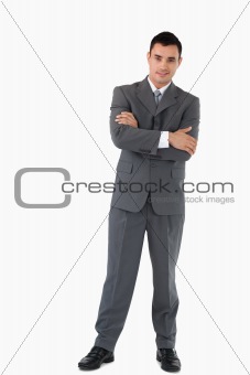 Businessman with arms folded against a white background