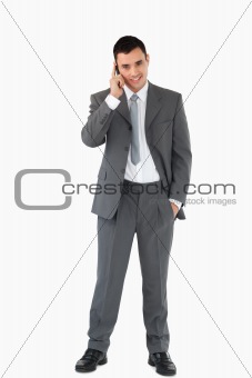 Businessman on the phone against a white background