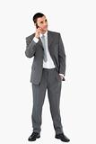 Businessman listening to caller against a white background