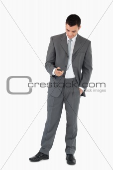 Businessman writing textmessage against a white background