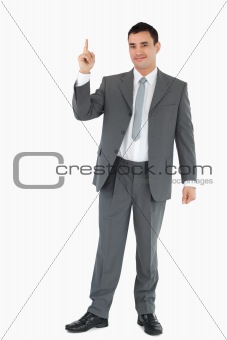 Businessman pointing upwards