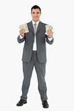 Businessman presenting banknotes with both hands
