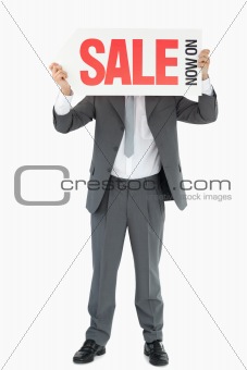 Businessman with sign in front of his head