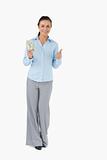 Smiling businesswoman with banknotes giving thumb up