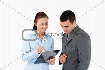 Businesswoman showing data to her partner