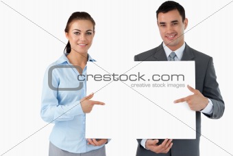 Business partners presenting sign together