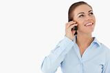 Smiling businesswoman looking upwards while on the phone